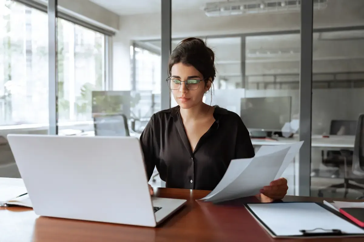 annual-reports-vs-operating-agreements-img.webp Business professional reviewing annual reports and operating agreements documents for LLC compliance and state filing requirements