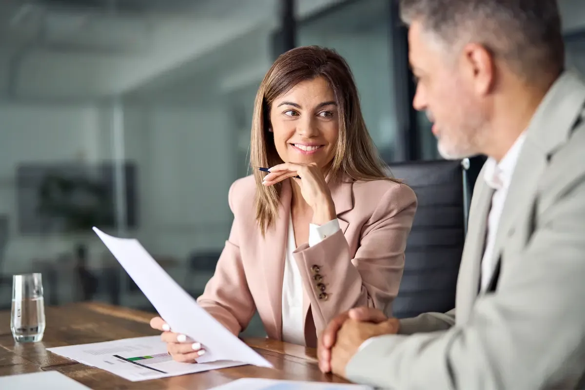 benefits-of-forming-and-llc-img.webp Business professionals discussing benefits of forming an LLC and why small businesses should form an LLC for personal asset protection and tax advantages.