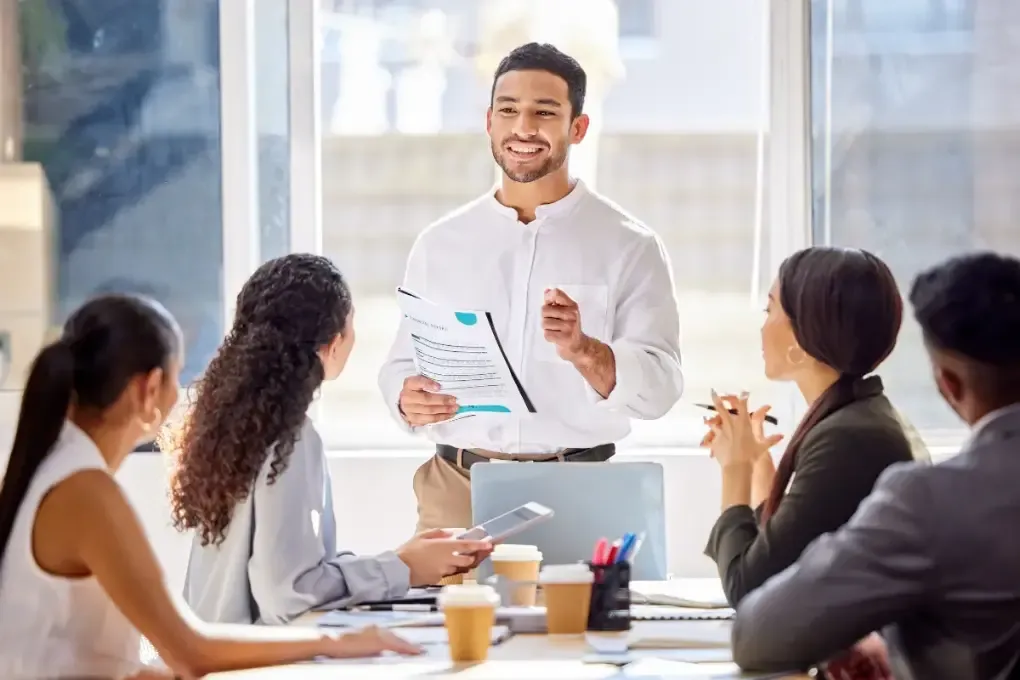 best-business-structure-img.webp Business consultant presenting different business structure options LLC corporation to entrepreneurs in office meeting.