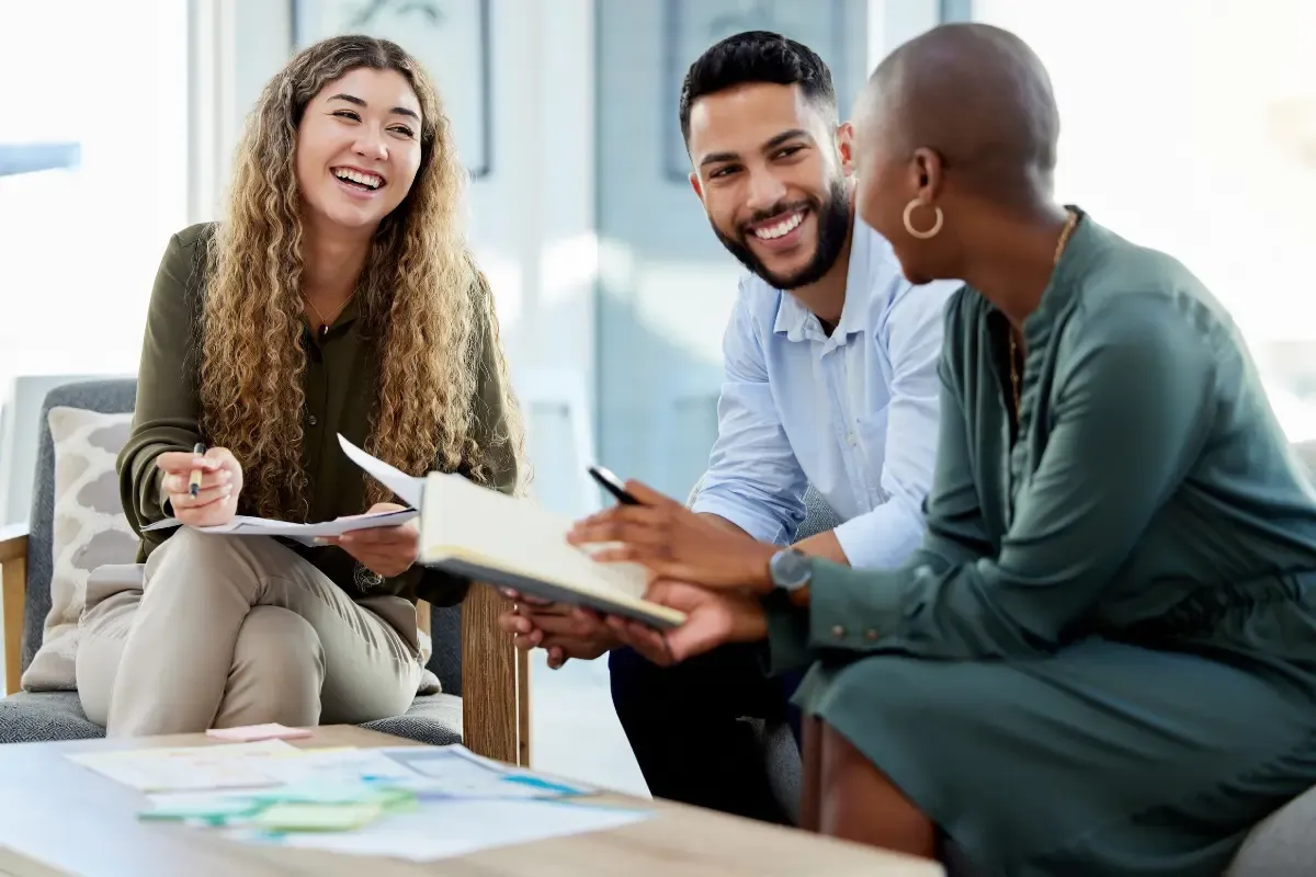 business-continuity-planning-img.webp Diverse business partners reviewing succession planning documents for small business continuity.