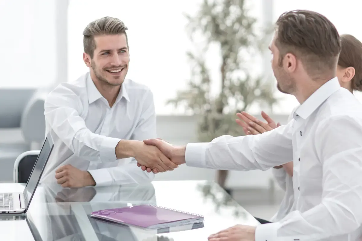 business-partner-img.webp Two business professionals shaking hands after signing a business partnership agreement, symbolizing LLC partner removal or addition during partnership changes.