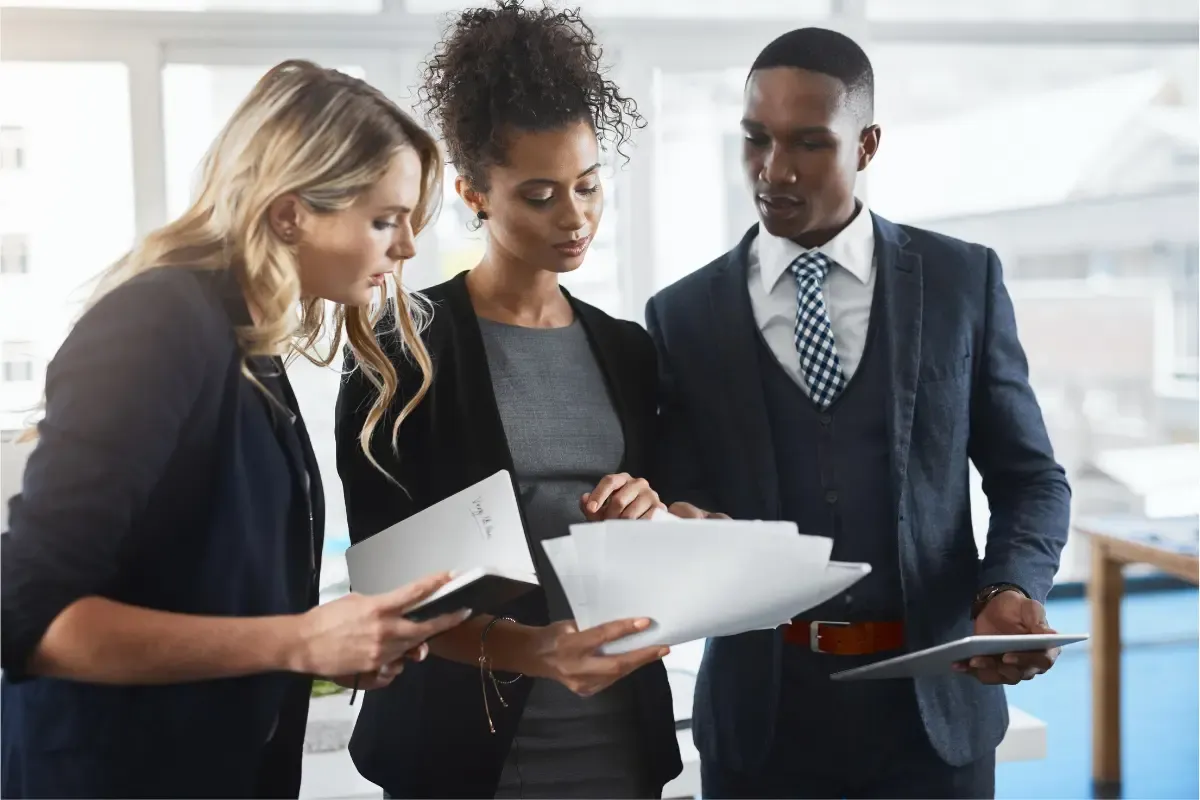 certificate-of-existence-img.webp Business professionals reviewing LLC certificate of existence and corporate good standing certificate documents for state business compliance verification