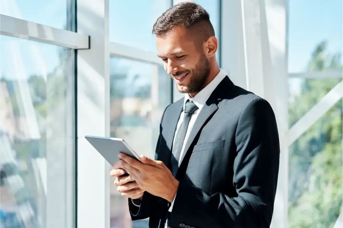 Business executive using entity management system for corporate compliance tracking and maintaining legal standing with compliance automation tools on tablet.