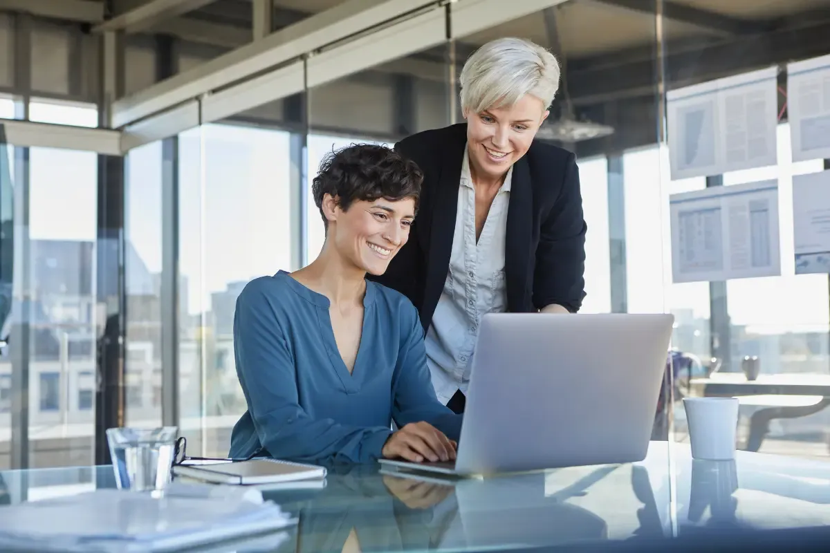 forming-your-company-img.webp Business advisors helping entrepreneur with company formation incorporation process on laptop in modern office.