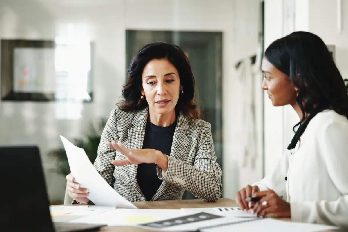 how-to-dissolve-an-llc-img.webp Business professionals reviewing LLC winding up procedures and discussing steps to dissolve an LLC and filing articles of dissolution requirements.