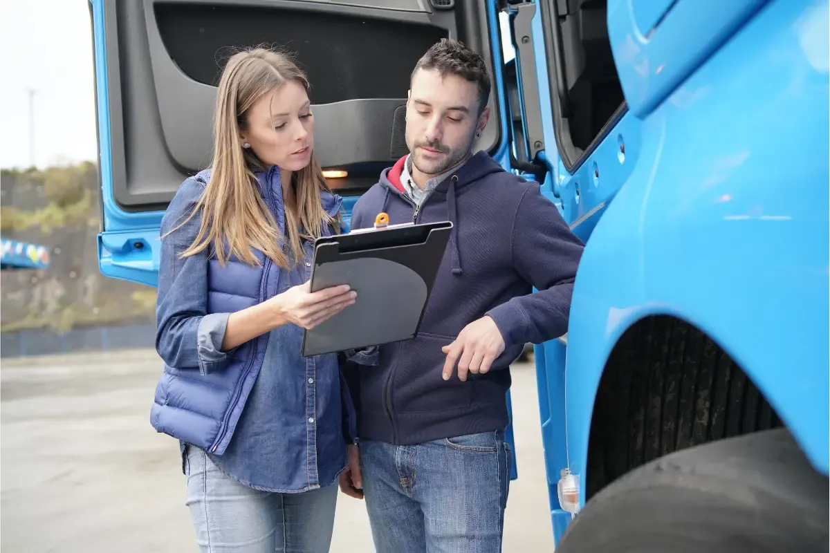 Trucking company owners reviewing DOT and MC number application requirements for box truck operating authority registration.
