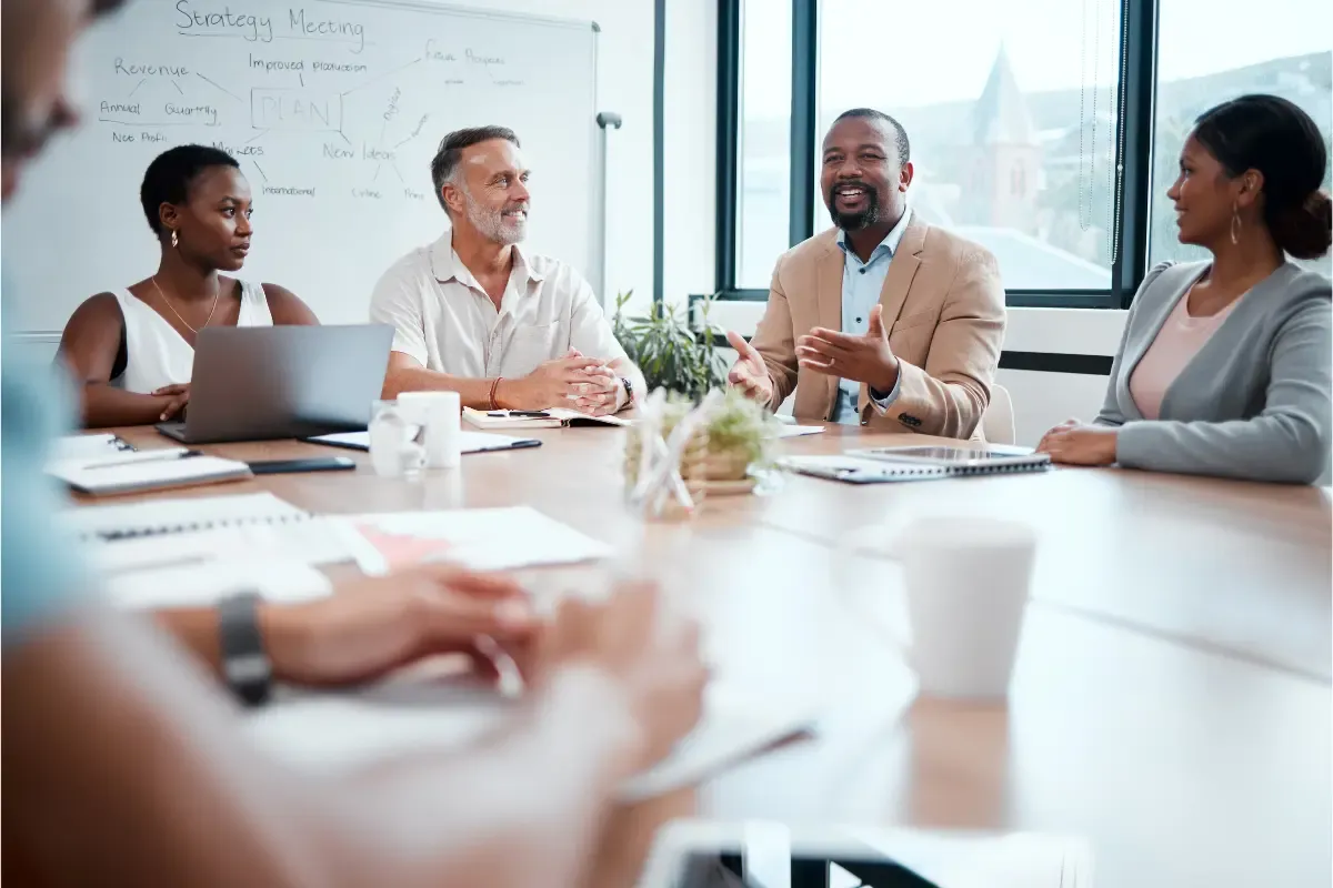 Business team discussing corporate governance updates after merger and legal compliance after acquisition including registered agent responsibilities and entity amendments.