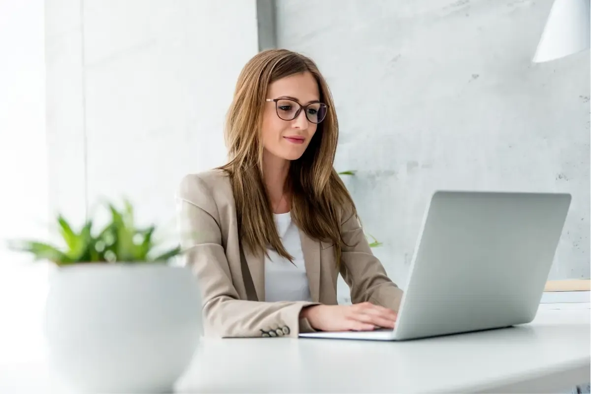 questions-to-ask-before-hiring-a-registered-agent-img.webp Business owner researching questions to ask before hiring a registered agent service and comparing company options online