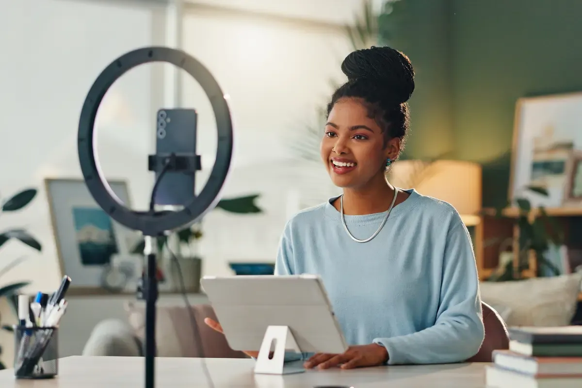 Content creator running a side hustle from home using professional recording and business tools.
